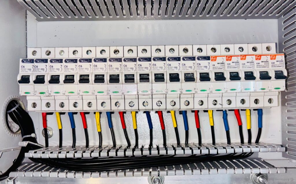pexels photo 28950842 Close-up of an organized circuit breaker panel featuring color-coded electrical wiring.